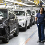 
              FILE - An employee works in the X3, X45 assembly hall at the BMW Spartanburg plant in Greer, S.C., Oct. 19, 2022. BMW said Wednesday, Oct. 19, that it will invest $1 billion in its sprawling factory near Spartanburg, to start building electric vehicles and an additional $700 million to build a battery plant nearby. (AP Photo/Sean Rayford, File)
            