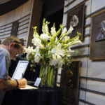 
              Christopher Rinkleib signs a book of condolence at the plaque of Loretta Lynn in the Country Music Hall of Fame Tuesday, Oct. 4, 2022, in Nashville, Tenn. Lynn, the Kentucky coal miner's daughter who became a pillar of country music, died Tuesday at her home in Hurricane Mills, Tenn. She was 90. (AP Photo/Mark Humphrey)
            