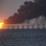 
              Flame and smoke rise fron Crimean Bridge connecting Russian mainland and Crimean peninsula over the Kerch Strait, in Kerch, Crimea, Saturday, Oct. 8, 2022. Russian authorities say a truck bomb has caused a fire and the partial collapse of a bridge linking Russia-annexed Crimea with Russia. Three people have been killed. The bridge is a key supply artery for Moscow's faltering war effort in southern Ukraine. (AP Photo)
            