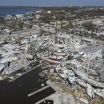 
              In this photo shot with a drone, shrimp boats lie grounded atop what was a mobile home park, following the passage of Hurricane Ian, on San Carlos Island in Fort Myers Beach, Fla., Friday, Oct. 7, 2022. (AP Photo/Rebecca Blackwell)
            