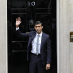 
              British Prime Minister Rishi Sunak waves from the steps of 10 Downing Street in London, Tuesday, Oct. 25, 2022. New British Prime Minister Rishi Sunak arrived at Downing Street Tuesday after returning from Buckingham Palace where he was invited to form a government by Britain's King Charles III. (AP Photo/Alastair Grant)
            