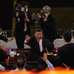 
              FILE - Chinese President Xi Jinping waves as he attends a gala show ahead of the 100th anniversary of the founding of the Chinese Communist Party in Beijing on June 28, 2021. Chinese President Xi Jinping was the son of a communist revolutionary leader, a victim of the Cultural Revolution and a provincial leader who promoted economic growth before ascending to the very top a decade ago. (AP Photo/Ng Han Guan, File)
            