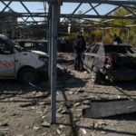 
              Police officers work at a site where several cars were damaged after a Russian attack in Zaporizhzhia, Ukraine, Saturday, Oct. 15, 2022. (AP Photo/Leo Correa)
            