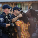 
              FILE - Brittany Martin, center, wearing striped clothing, confronts police as demonstrators in support of George Floyd march with an escort around downtown Sumter, S.C., on May 31, 2020. Martin, a pregnant Black activist serving four years in prison over comments she made to police during racial justice protests in the summer of 2020, will not receive a lesser sentence, a judge has ruled. (Micah Green/The Item via AP, File)
            
