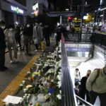 
              Flowers are displayed to pay tribute for victims near the scene of a deadly accident in Seoul, South Korea, Sunday, Oct. 30, 2022, following Saturday night's Halloween festivities. A mass of mostly young people celebrating Halloween festivities in Seoul became trapped and crushed as the crowd surged into a narrow alley, killing dozens of people and injuring dozens of others in South Korea's worst disaster in years. (AP Photo/Ahn Young-joon)
            