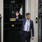 
              New British Prime Minister Rishi Sunak waves after arriving at Downing Street in London, Tuesday, Oct. 25, 2022, after returning from Buckingham Palace where he was formally appointed to the post by Britain's King Charles III. (AP Photo/Kin Cheung)
            