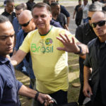 
              Brazilian President Jair Bolsonaro, who is running for another term, arrives to vote in a second round presidential election in in Rio de Janeiro, Brazil, Sunday, Oct. 30, 2022. (AP Photo/Silvia Izquierdo)
            