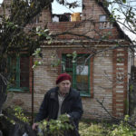 
              Vladimir Semenets, 84, stands in front of his damaged house in the retaken village of Bohorodychne, eastern Ukraine, Saturday, Oct. 22, 2022. (AP Photo/Andriy Andriyenko)
            