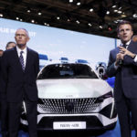French President Emmanuel Macron, right, speaks next to Carlos Tavares, Peugeot chairman and Stellantis chief executive, at the Paris Car Show, Monday, Oct. 17, 2022. Europe is leading the charge into electric vehicles as battery powered cars break out of their niche market of first adopters and enter the mainstream with increasing market share that's forecast to grow strongly as the EU pushes to phase out internal combustion engine vehicles by 2035 (Gonzalo Fuentes/Pool via AP)
