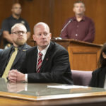 
              Attorney General prosecutors listen to the verdict in a trial on Wednesday, Oct. 26, 2022, at the Jackson County Courthouse in Jackson, Mich. Paul Bellar, Joseph Morrison and Pete Musico are accused of being involved in a plot to kidnap Michigan Gov. Gretchen Whitmer. The three were found guilty of one felony count each of gang membership, providing material support for terrorist acts and felony firearms. (J. Scott Park/Jackson Citizen Patriot via AP, Pool)
            