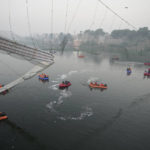 
              Search and rescue work is going on as a cable suspension bridge collapsed in Morbi town of western state Gujarat, India, Monday, Oct. 31, 2022. The century-old cable suspension bridge collapsed into the river Sunday evening, sending hundreds plunging in the water, officials said. (AP Photo/Ajit Solanki)
            