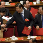 
              FILE - Shanghai party chief Xi Jinping, center, shakes hands with other delegates during the closing ceremony for the 17th Communist Party Congress held at the Great Hall of the People in Beijing, China on Oct. 21, 2007. Chinese President Xi Jinping was the son of a communist revolutionary leader, a victim of the Cultural Revolution and a provincial leader who promoted economic growth before ascending to the very top a decade ago. (AP Photo/Ng Han Guan, File)
            