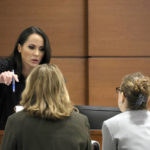 
              Judge Elizabeth Scherer speaks with assistant state attorney Carolyn McCann, left, and assistant public defender Tamara Curtis during jury instructions in the penalty phase of the trial of Marjory Stoneman Douglas High School shooter Nikolas Cruz at the Broward County Courthouse in Fort Lauderdale, Fla. on Wednesday, Oct. 12, 2022. Cruz previously plead guilty to all 17 counts of premeditated murder and 17 counts of attempted murder in the 2018 shootings. (Amy Beth Bennett/South Florida Sun Sentinel via AP, Pool)
            