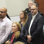 
              CORRECTS DATE - Kelly and Ryan Petty are shown as family members of the victims stand while the jury enters the courtroom for jury instructions in the penalty phase of the trial of Marjory Stoneman Douglas High School shooter Nikolas Cruz at the Broward County Courthouse in Fort Lauderdale, Fla. on Wednesday, Oct. 12, 2022. The Petty's daughter, Alaina, was killed in the 2018 shootings. Cruz previously plead guilty to all 17 counts of premeditated murder and 17 counts of attempted murder in the 2018 shootings. (Amy Beth Bennett/South Florida Sun Sentinel via AP, Pool)
            