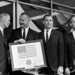 FILE - Vice President Spiro Agnew holds a framed American flag, presented to him by the crew of Apollo 9, as he poses with the astronauts March 26, 1969, in Washington. From left: Russell Schweikart, Agnew, and Air Force Cols. David Scott and James McDivitt. McDivitt, who commanded the Apollo 9 mission testing the first complete set of equipment to go to the moon, died Thursday, Oct. 13, 2022. He was 93. (AP Photo/Harvey Georges, File)