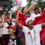 
              Supporters of Brazil's former President Luiz Inacio Lula da Silva, who is running for president again, rally after the closing of the polls for a presidential run-off election in Sao Paulo, Brazil, Sunday, Oct. 30, 2022. (AP Photo/Matias Delacroix)
            
