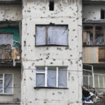 
              Traces of shrapnel from the Russian rockets cover a multi storey house in central Slavyansk, Donetsk region, Ukraine, Saturday, Oct. 29, 2022. (AP Photo/Efrem Lukatsky)
            