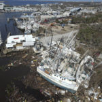 
              In this photo shot with a drone, grounded shrimp boats lie bunched together amidst debris, following the passage of Hurricane Ian, on San Carlos Island in Fort Myers Beach, Fla., Friday, Oct. 7, 2022. (AP Photo/Rebecca Blackwell)
            