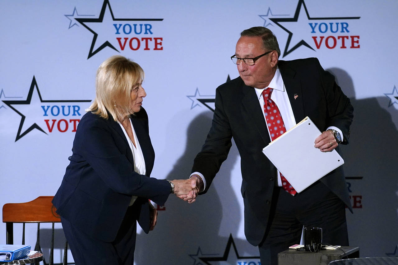 Democratic Gov. Janet Mills and Republican Paul LePage shake hands following a debate, Tuesday, Oct...