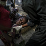 
              A youth suffering cholera symptoms is helped upon arrival at a clinic run by Doctors Without Borders in Port-au-Prince, Haiti, Thursday, Oct. 27, 2022. For the first time in three years, people in Haiti have been dying of cholera, raising concerns about a potentially fast-spreading scenario and reviving memories of an epidemic that killed nearly 10,000 people a decade ago. (AP Photo/Ramon Espinosa)
            