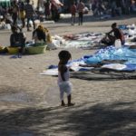 
              A child plays with an inflated condom at the Hugo Chavez public square transformed into a refuge for families forced to leave their homes due to clashes between armed gangs in Port-au-Prince, Haiti, Thursday, Oct. 20, 2022. (AP Photo/Odelyn Joseph)
            