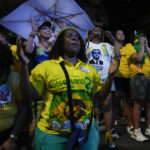 
              Supporters of Brazilian President Jair Bolsonaro gather after polls closed in a presidential run-off election in Rio de Janeiro, Brazil, Sunday, Oct. 30, 2022. Brazilians had to choose between former President Luiz Inacio Lula da Silva and Bolsonaro, after neither got enough support to win outright in the Oct. 2 general election. (AP Photo/Silvia Izquierdo)
            