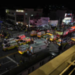
              Ambulances and rescue workers arrive near the scene of an incident, in Seoul, South Korea, Sunday, Oct. 30, 2022. South Korean officials say at least 120 people were killed and 100 more were injured as they were crushed by a large crowd pushing forward on a narrow street during Halloween festivities in the capital of Seoul. Choi Seong-beom, chief of Seoul’s Yongsan fire department, said the death toll could rise, saying that an unspecified number among the injured were in critical conditions.  (AP Photo/Lee Jin-man)
            