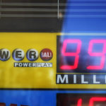 
              A display that only shows three digits, in millions, is maxed out at $999 million, despite the Monday Powerball drawing with an annuity value of at least $1.9 billion, is seen through the window where tickets are sold at a convenience store, Monday, Nov. 7, 2022, in Renfrew, Pa. (AP Photo/Keith Srakocic)
            