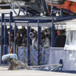 
              Migrants stand on the deck of the Humanity 1 rescue ship run by the German organization SOS Humanitarian, at harbor in the port of Catania, Sicily, southern Italy, Sunday, Nov. 6, 2022. The captain of the Humanity 1 refused Italian orders to leave a Sicilian port Sunday after authorities conducted a medical selection of the passengers and did not allow 35 to get off, acting under directives from Italy's far-right-led government. (AP Photo/Salvatore Cavalli)
            