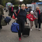 
              FILE - Evacuees from Kherson arrive at the railway station in Anapa, southern Russia, Oct. 25, 2022. Russia relinquished its final foothold in a major city in southern Ukraine on Friday Nov. 11, 2022, clearing the way for victorious Ukrainian forces to reclaim the country’s only Russian-held provincial capital that could act as a springboard for further advances into occupied territory. (AP Photo, File)
            
