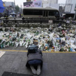 
              A man bows to pay tribute to victims of a deadly accident following Saturday night's Halloween festivities on a street near the scene in Seoul, South Korea, Tuesday, Nov. 1, 2022.  South Korean police investigated on Monday what caused a crowd surge that killed more than 150 people during Halloween festivities in Seoul in the country’s worst disaster in years. (AP Photo/Ahn Young-joon)
            