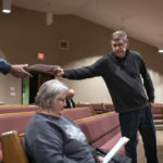 
              Pastor Rick Mannon passes out material during a Bible study at Calvary Assembly of God in Wilson, Wis., Wednesday, Nov. 16, 2022. Mannon preaches a Christianity that resonates deeply among the insurgent conservatives, with strict lines of good and evil and little hesitation to wade into cultural and political issues. He pushed back hard against COVID restrictions. (AP Photo/David Goldman)
            