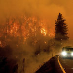 
              FILE - A firetruck drives along California Highway 96 as the McKinney Fire burns in Klamath National Forest, Calif., on July 30, 2022. 90% of counties in the United States experienced a weather-related disaster between 2011-2021, according to a report published on Wednesday, Nov. 16, 2022. Over 300 million people — 93% of the country’s population — live in those counties. (AP Photo/Noah Berger, File)
            