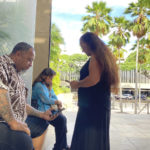 
              Chico Kaonohi, left, prays with Priscilla Hoʻopiʻi, center, and Lana Vierra, right, outside U.S. District Court in Honolulu, Thursday, Nov. 17, 2022, after his Native Hawaiian son was found guilty of a hate crime in the 2014 beating of a white man. U.S. District Judge J. Michael Seabright ordered Kaulana Alo-Kaonohi and Levi Aki Jr. detained pending sentencing scheduled for March 2, 2023. (AP Photo/Jennifer Sinco Kelleher)
            