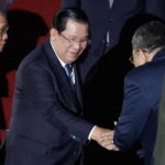 
              Cambodia's Prime Minister Hun Sen, center,  arrives at Ngurah Rai International Airport ahead of the G20 Summit in Bali, Indonesia on Nov. 14, 2022. Hun Sen tests positive for COVID-19 at G-20, days after hosting world leaders at summit in Phnom Penh. (Ajeng Dinar Ulfiana/Pool Photo via AP)
            