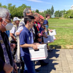 
              FILE - Backers of a proposed initiative that would require individuals to secure permits to buy firearms and ban large-capacity magazines deliver the signatures of thousands of voters on July 8, 2022, to state election offices in Salem, Ore. Voters in several states are deciding measures that could affect the way they cast ballots in future elections. While some measures would expand access to voting, proposals elsewhere would impose new identification requirements to cast ballots or raise the threshold to pass citizen initiatives.(AP Photo/Andrew Selsky, File)
            