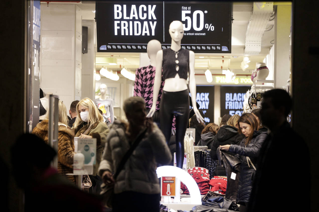 FILE - People shop during Black Friday sales in Via del Corso in Rome, Friday, Nov. 25, 2022. Infla...