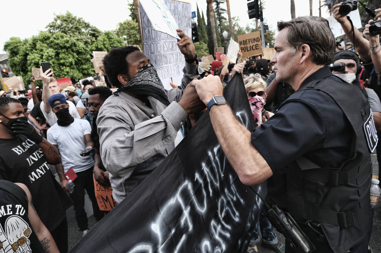 FILE - Los Angeles Captain Cory Palka, right reaches out and offers a handshake to a "Black Lives M...