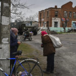 
              People carry food after receiving it at a humanitarian aid point in the village of Drobysheve, Donetsk region, Ukraine, Friday, Nov. 18, 2022. (AP Photo/Andriy Andriyenko)
            