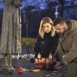 
              In this photo provided by the Ukrainian Presidential Press Office, Ukrainian President Volodymyr Zelenskyy and his wife Olena pay tribute at a monument to victims of the Holodomor, Great Famine, which took place in the 1930's and that killed millions, in Kyiv, Ukraine, Saturday, Nov. 26, 2022. (Ukrainian Presidential Press Office via AP)
            