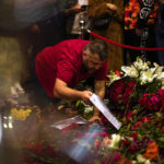 
              A man places flowers and photographs in the memorial spot of Sunday's explosion on Istanbul's popular pedestrian Istiklal Avenue in Istanbul, Turkey, Monday, Nov. 14, 2022. Turkish police said Monday they have detained a Syrian woman with suspected links to Kurdish militants and that she confessed to planting a bomb that exploded on a bustling pedestrian avenue in Istanbul, killing six people and wounding several dozen others. (AP Photo/Francisco Seco)
            
