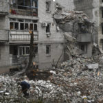 
              A man cleans debris of the destroyed house after recent Russian air strike in Chasiv Yar, Ukraine, Sunday, Nov. 27, 2022. Shelling by Russian forces struck several areas in eastern and southern Ukraine overnight as utility crews continued a scramble to restore power, water and heating following widespread strikes in recent weeks, officials said Sunday. (AP Photo/Andriy Andriyenko)
            