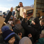 
              People receive humanitarian aid on central square in Kherson, Ukraine, Tuesday, Nov. 15, 2022. Waves of Russian airstrikes rocked Ukraine on Tuesday, with authorities immediately announcing emergency blackouts after attacks from east to west on energy and other facilities knocked out power and, in the capital, struck residential buildings. (AP Photo/Efrem Lukatsky)
            