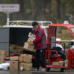 
              A delivery courier sorts packages along a street in Beijing, Friday, Nov. 11, 2022. China's biggest online shopping festival, known as Singles' Day, is typically an extravagant affair as Chinese e-commerce firms like Alibaba and JD.com ramp up marketing campaigns and engage top livestreamers to hawk everything from lipstick to furniture as they race to break sales records of previous years. (AP Photo/Mark Schiefelbein)
            