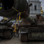 
              Pedestrians stand in front of a display of destroyed Russian tanks and armoured vehicles in downtown Kyiv, Ukraine, Monday, Nov. 7, 2022. (AP Photo/Bernat Armangue)
            