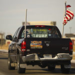 
              A truck flying an American flag and displaying signs supporting former President Donald Trump drives near Kalispell, Mont., on Tuesday, Nov. 8, 2022. (AP Photo/Tommy Martino)
            