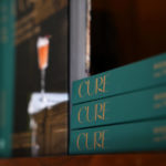 
              Copies of his new book "Cure: New Orleans Drinks and How to Mix 'Em" sit on the shelves of Cure, a craft cocktail bar founded by author Neal Bodenheimer, in New Orleans, Friday, Nov. 18, 2022. (AP Photo/Gerald Herbert)
            