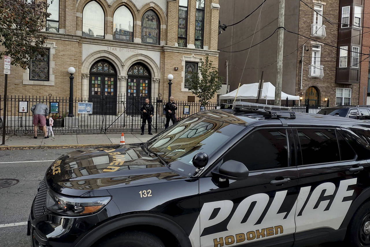 Hoboken Police officers stand watch outside the United Synagogue of Hoboken, Thursday, Nov. 3, 2022...