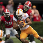 
              Tennessee tight end Jacob Warren (87) makes a catch as Georgia defensive back Javon Bullard (22) defends during the first half of an NCAA college football game Saturday, Nov. 5, 2022 in Athens, Ga. (AP Photo/John Bazemore)
            