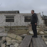 
              Vadym Zherdetsky stands amid the wreckage of his house destroyed by fighting in the village of Moshun, outside Kyiv, Ukraine, Friday, Nov. 4, 2022. When Russia invaded Ukraine in February, two missiles struck Zherdetsky's home in the tiny village of Moschun on the outskirts of the capital, Kyiv, ripping the roof off and nearly killing four of his family members. (AP Photo/Andrew Kravchenko)
            